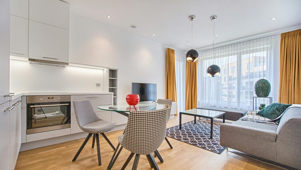 Elegant Scandinavian-style living room and kitchen featuring modern furniture and decor.