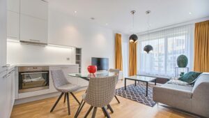 Elegant Scandinavian-style living room and kitchen featuring modern furniture and decor.